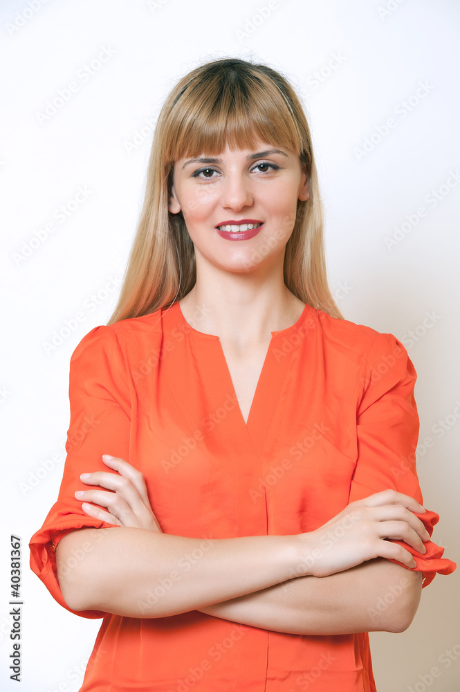 Fototapeta premium Beautiful European young woman standing with her hands folded.