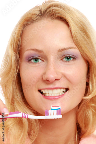 A young woman brushing teeth, closeup, isolated on white