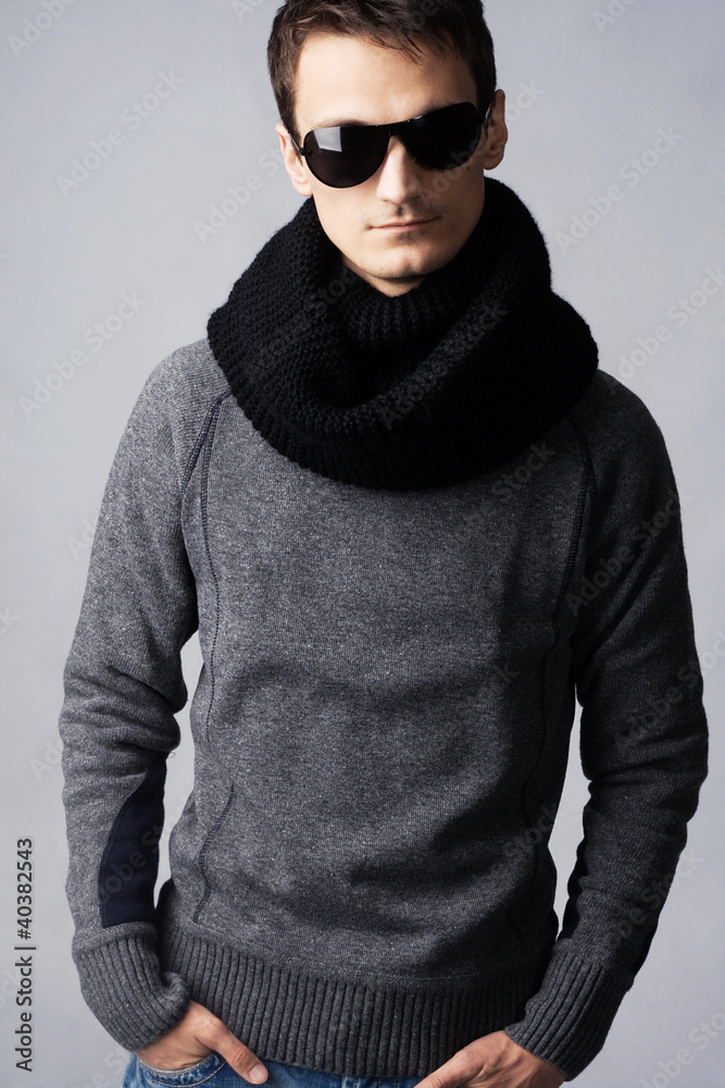 Stylish handsome man in dark sunglasses and black scarf Stylish handsome man in dark sunglasses and black scarf