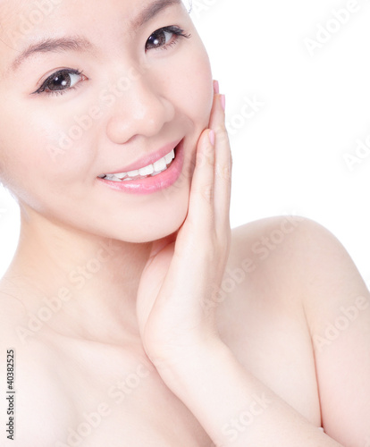 woman touching her pretty face with healthy skin
