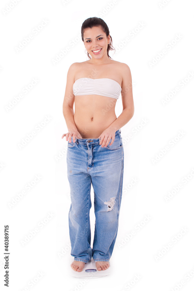 Pretty woman shows her weight loss by wearing an old jeans Pretty woman shows her weight loss by wearing an old jeans