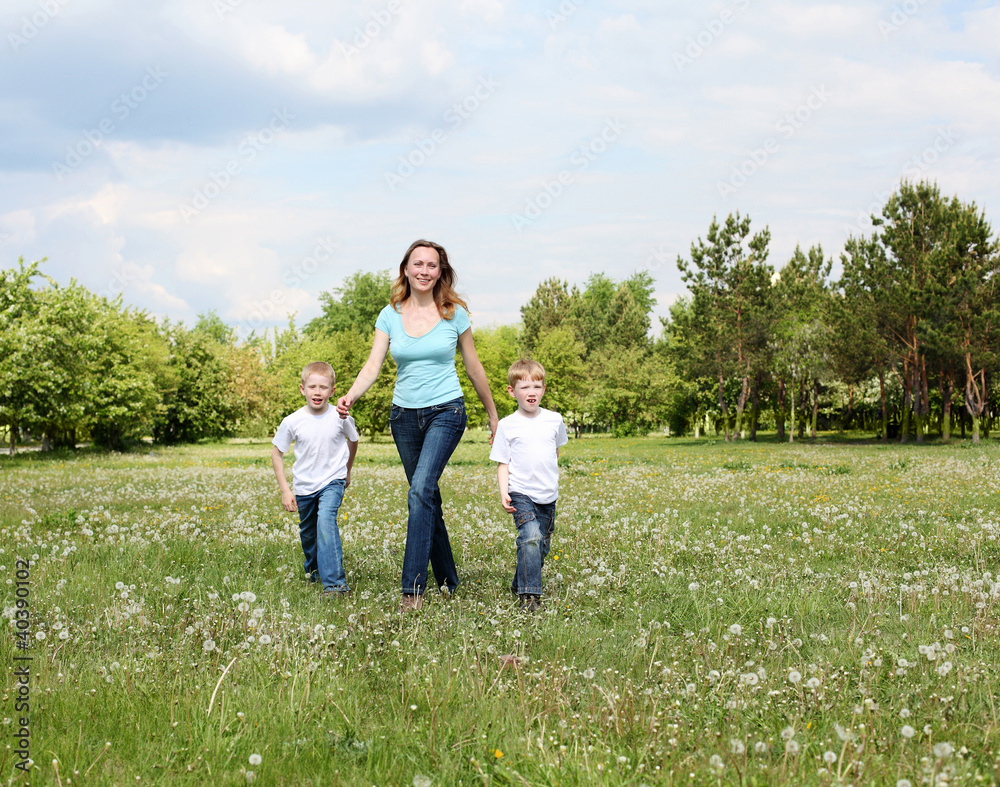 Fototapeta premium mother with her two sons outdoors