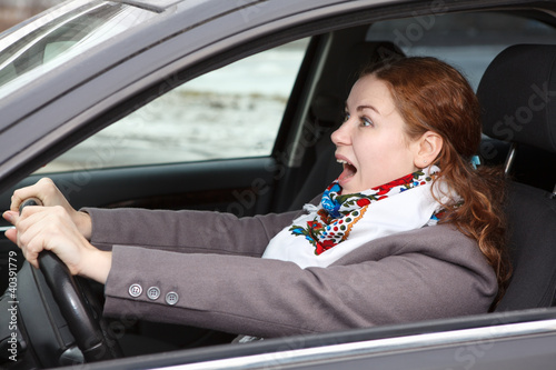 Pretty young woman stopping the car and screaming