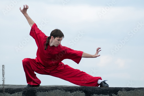 Wushoo man in red practice martial art photo