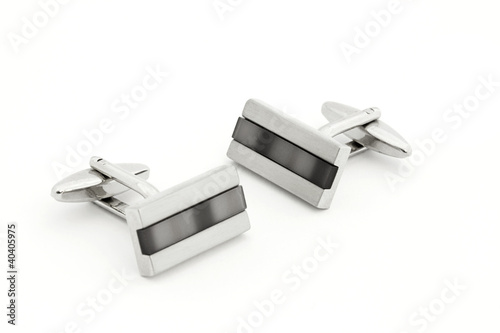 Pair of silver cuff links over white photo