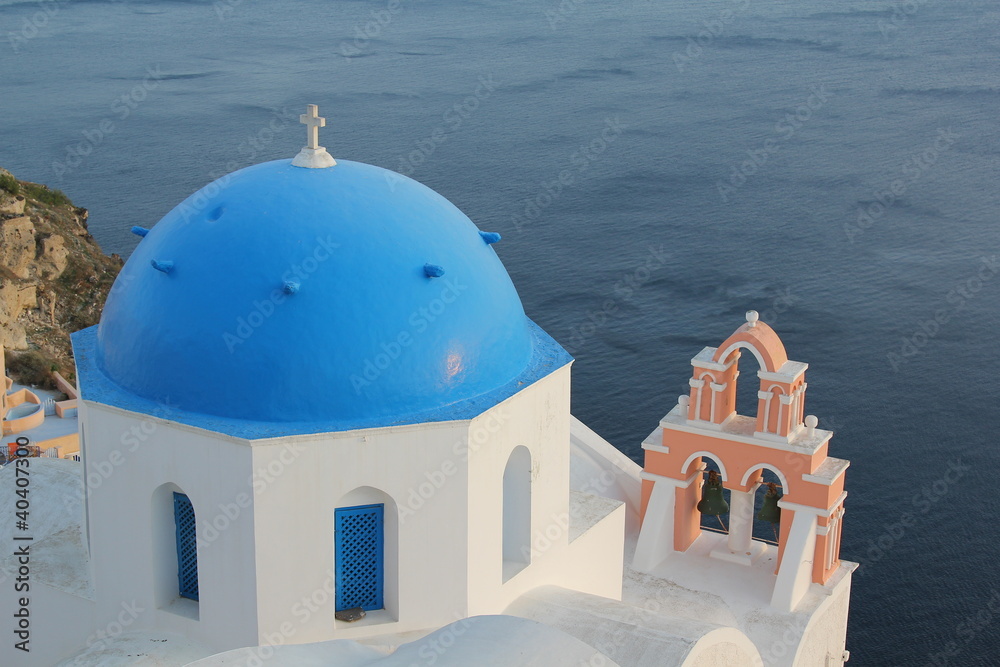 Church Dome and Bell at sunset in Oia