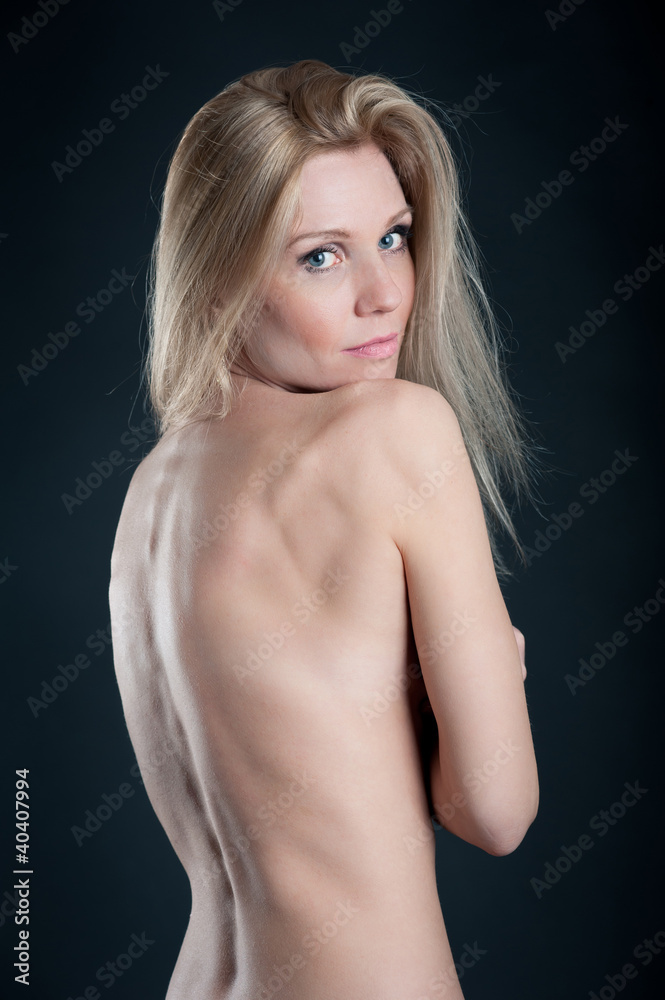 Seductive blond woman portrait against black background. Seductive blond woman portrait against black background.