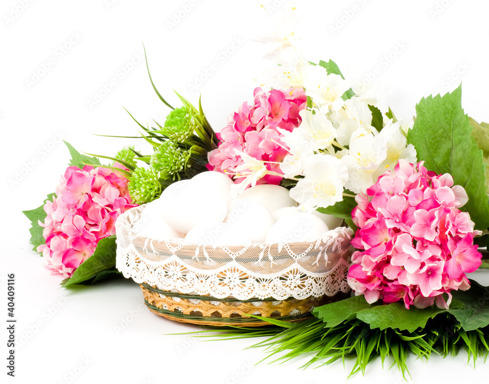 Basket with Easter eggs and spring flowers Basket with Easter eggs and spring flowers
