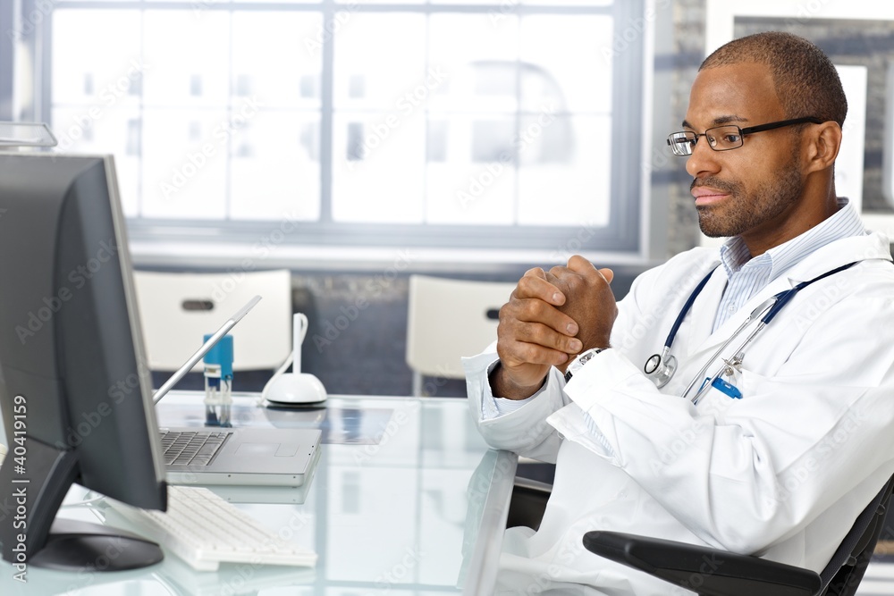 Troubled doctor sitting at desk Troubled doctor sitting at desk