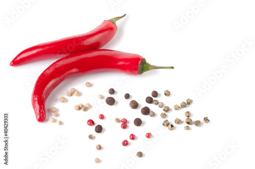 Two red chili peppers and various assorted pepper