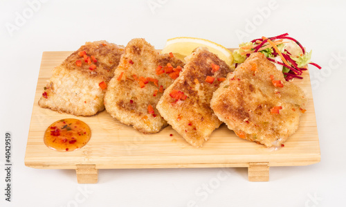 Fried fish fillets with salad.