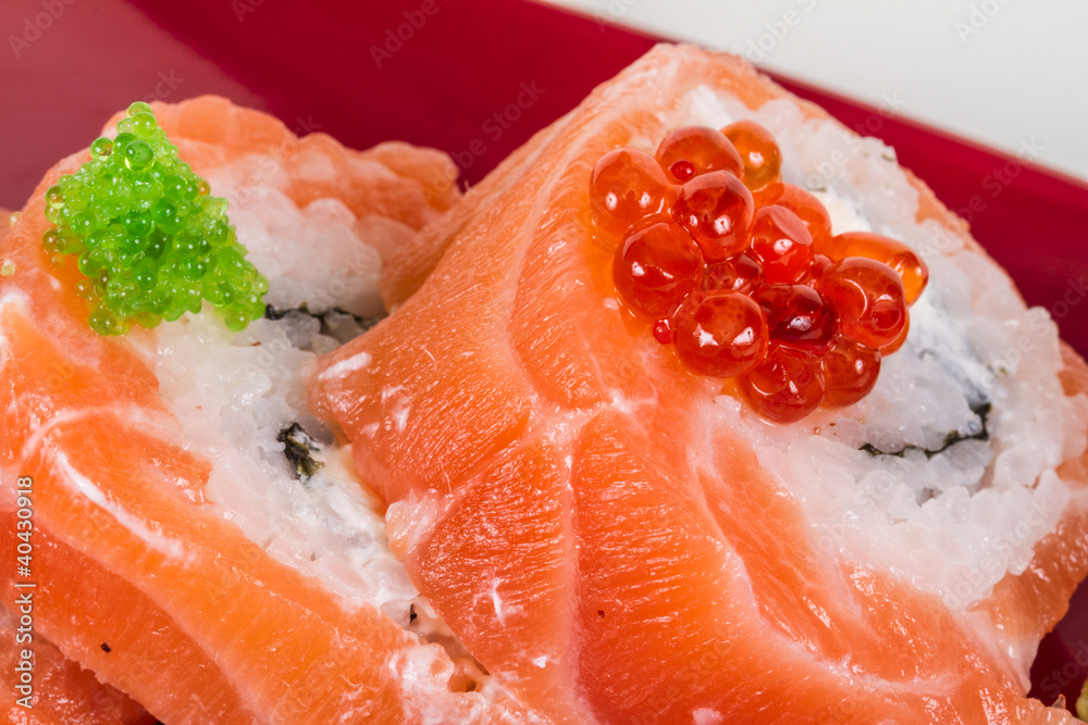 Japanese sushi traditional japanese food.Roll made of salmon, re Japanese sushi traditional japanese food.Roll made of salmon, re