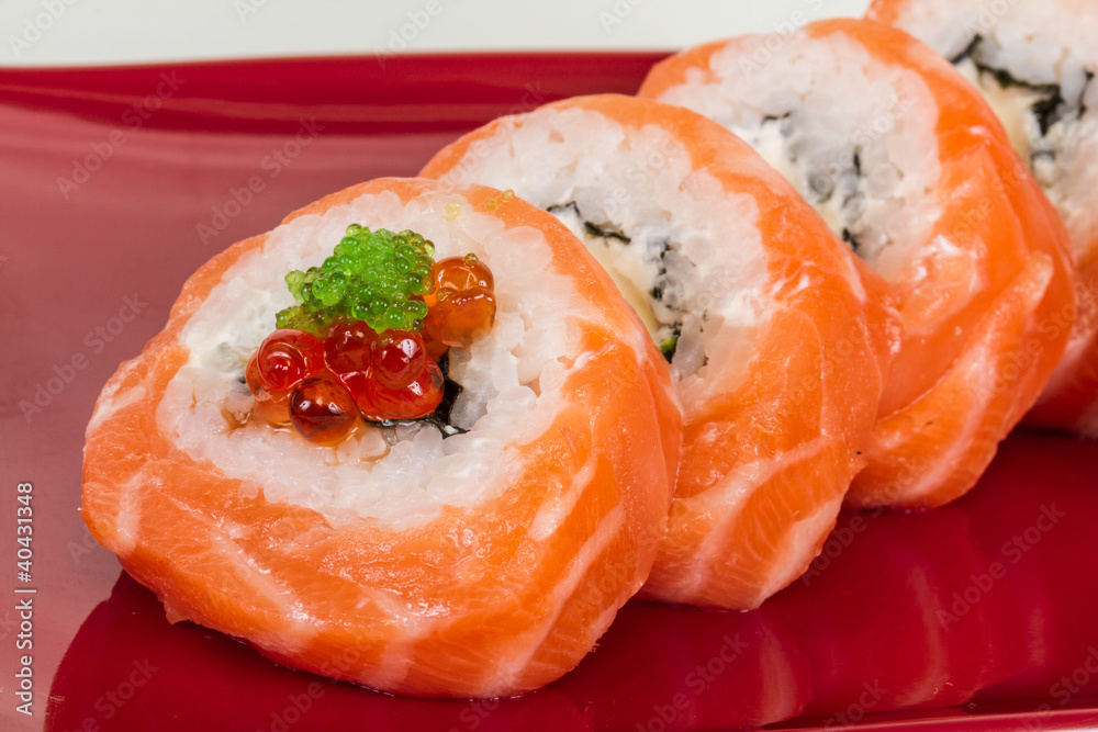 Japanese sushi traditional japanese food.Roll made of salmon, re Japanese sushi traditional japanese food.Roll made of salmon, re