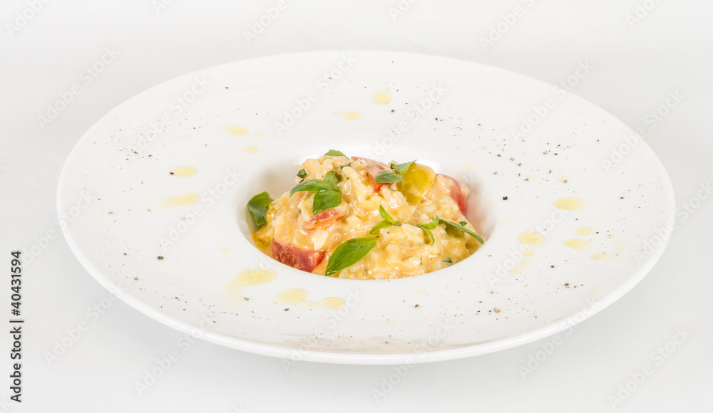 photo of delicious risotto dish with herbs and tomato on white b