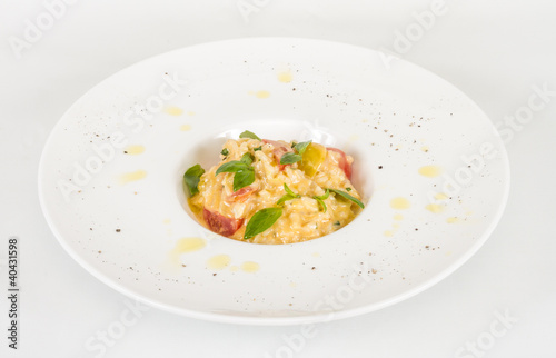 photo of delicious risotto dish with herbs and tomato on white b