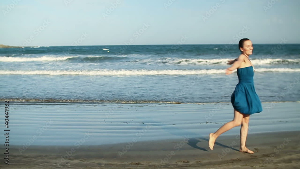 Happy woman turning around on the beach, slow motion Happy woman turning around on the beach, slow motion