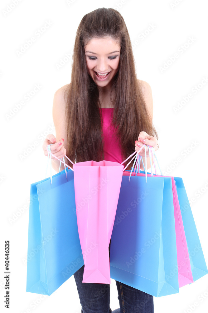 Happy teenager looking into shopping bags Happy teenager looking into shopping bags