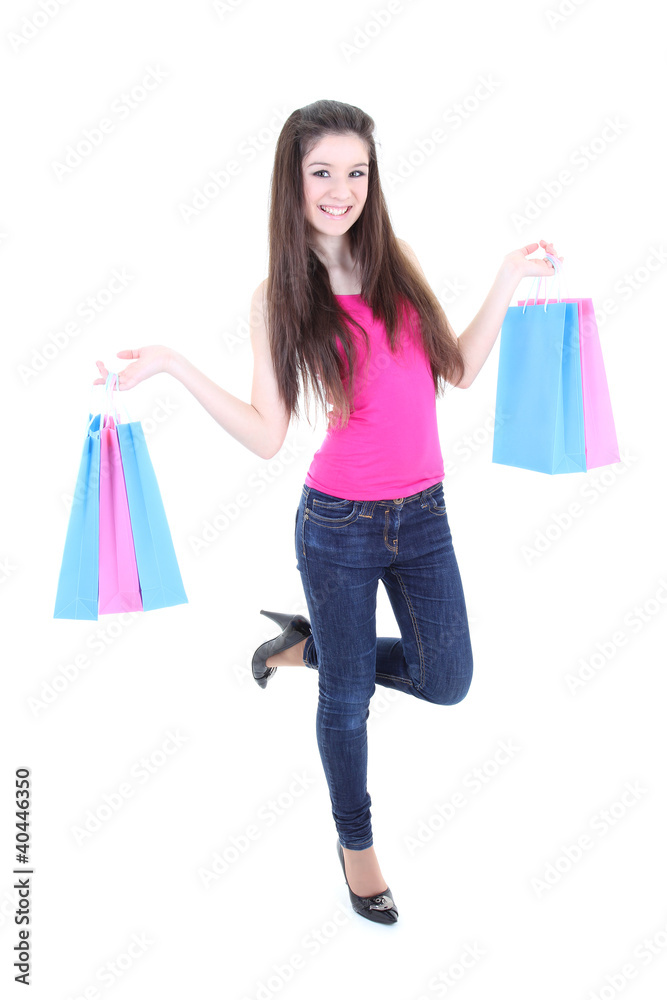 Happy teenager in pink t-shirt with shopping bags