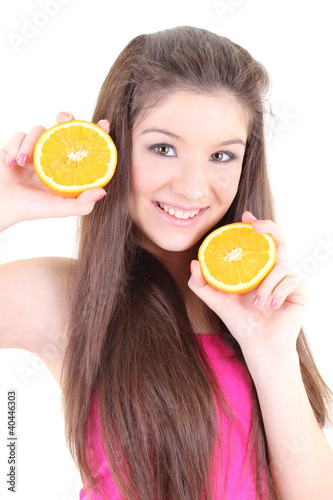 Happy teenager in pink with half of oranges