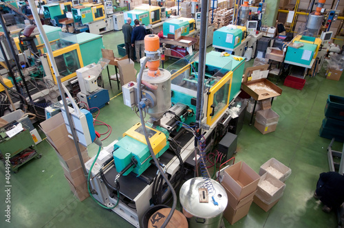 Injection molding machines in a large factory photo