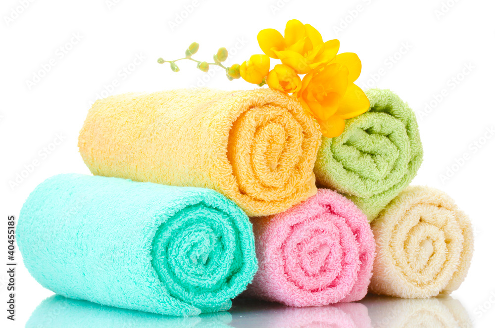 colorful towels and flowers isolated on white colorful towels and flowers isolated on white