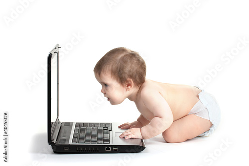 Cute baby girl and laptop i...