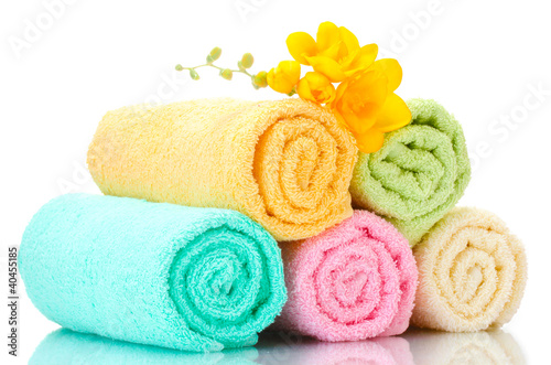 colorful towels and flowers isolated on white photo