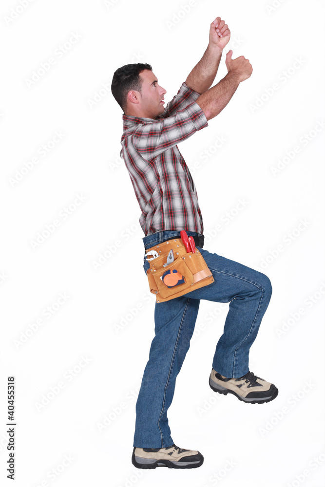 Naklejka premium A handyman miming.