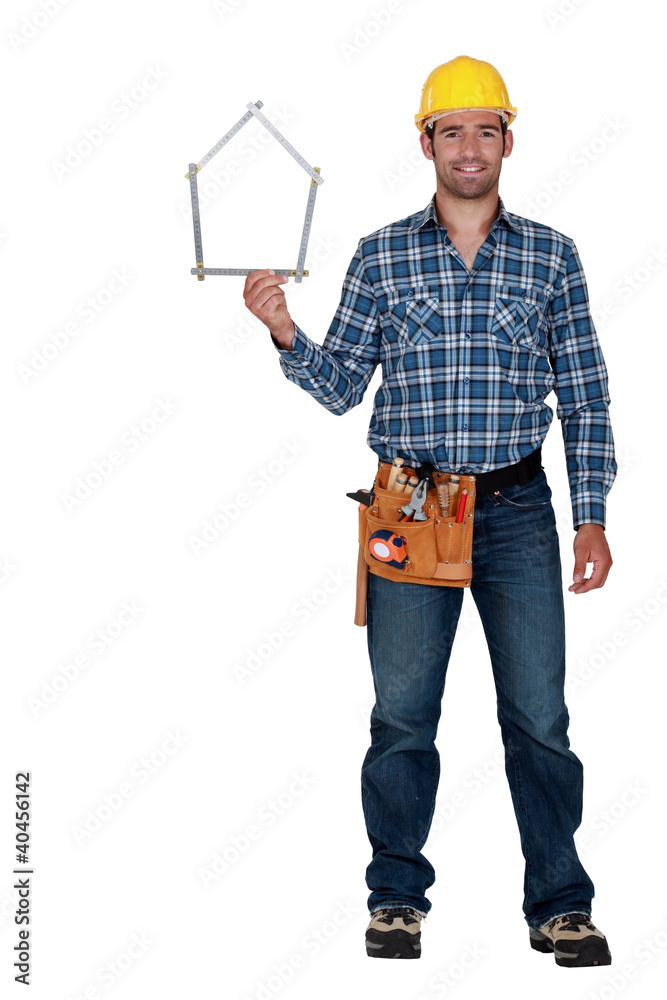 Man holding house-shaped measuring device Man holding house-shaped measuring device