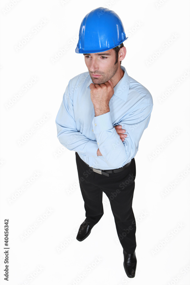 businessman wearing helmet and thinking businessman wearing helmet and thinking