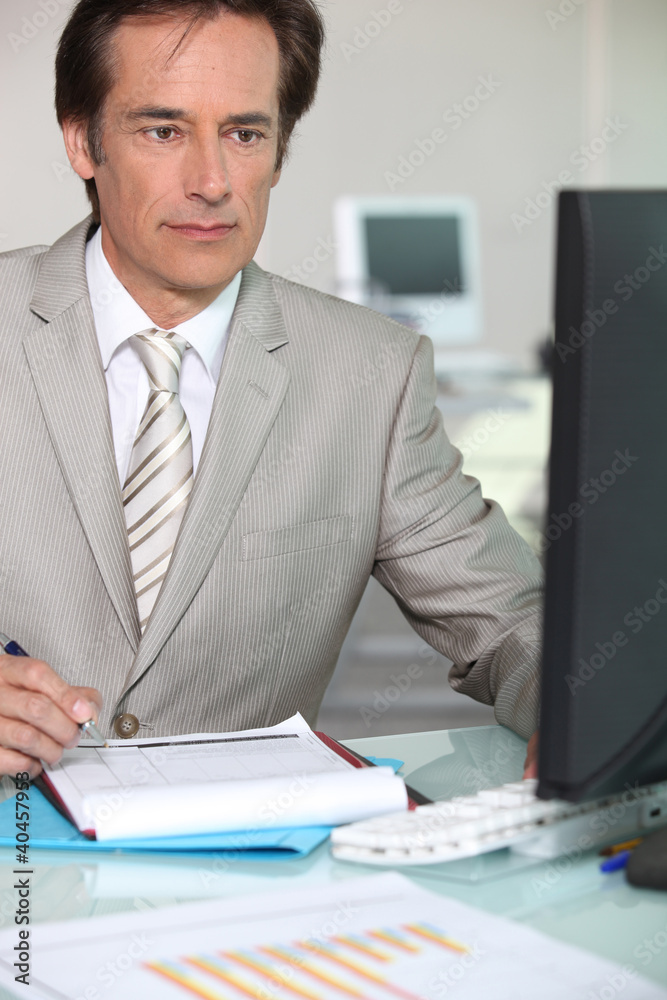 Mature businessman working at his desk Mature businessman working at his desk