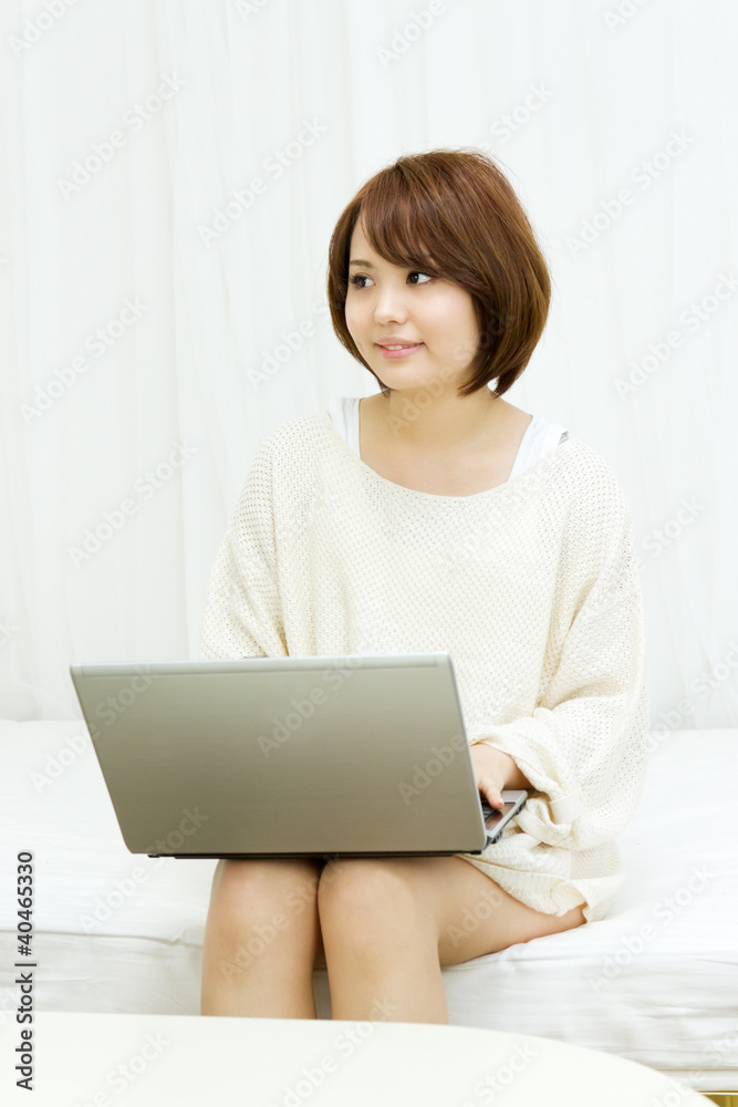 Beautiful asian woman using a laptop computer Beautiful asian woman using a laptop computer