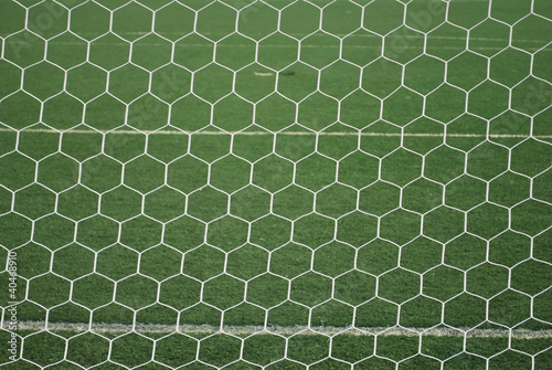 Behind goal net at football field