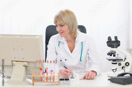 Middle age doctor woman working at office