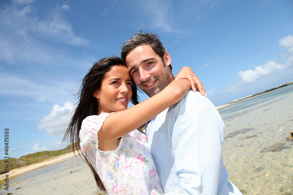 Couple of lovers embracing each other at the beach Couple of lovers embracing each other at the beach