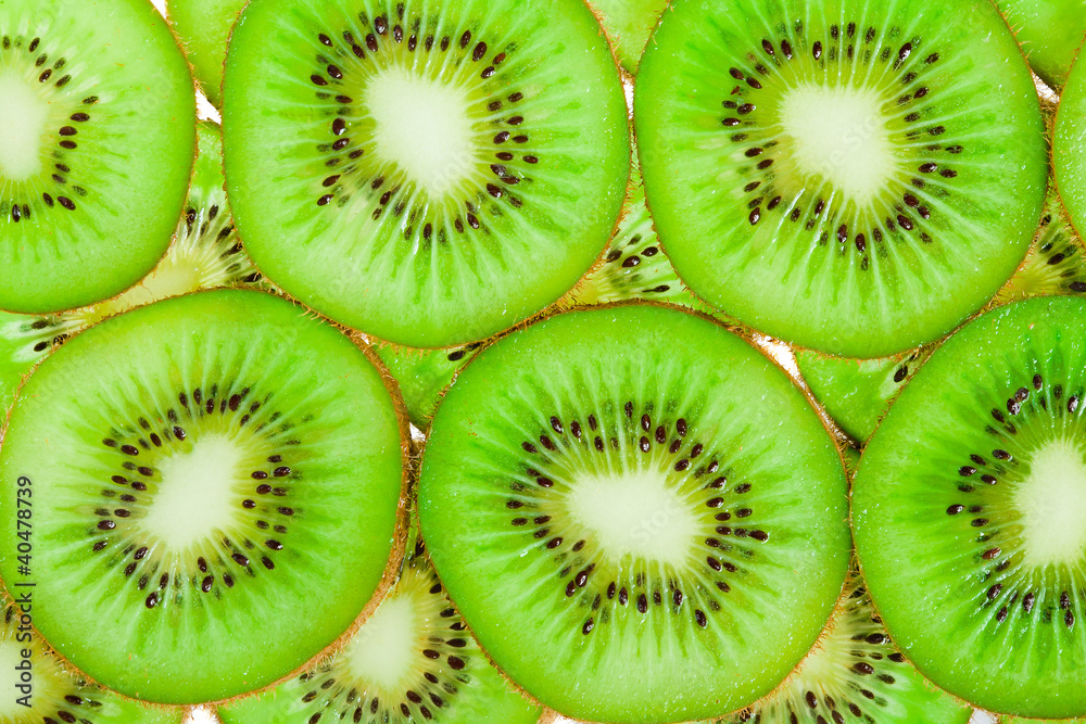 close up background of green kiwi slices close up background of green kiwi slices