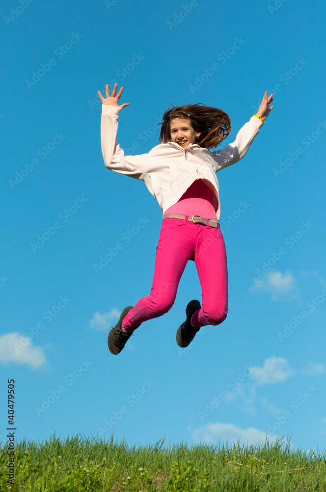 Cute teenage girl jumping with joy on sunny spring day Cute teenage girl jumping with joy on sunny spring day