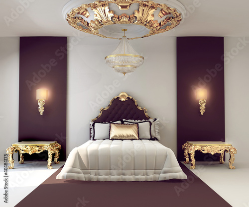 Luxury double bedroom with golden furniture in royal interior