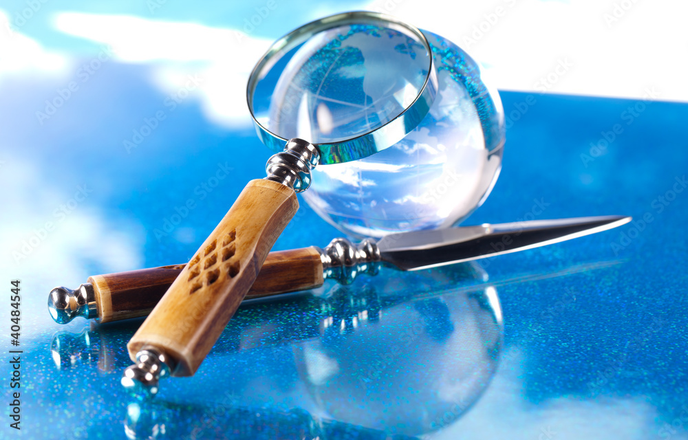 magnifying glass knife and globe