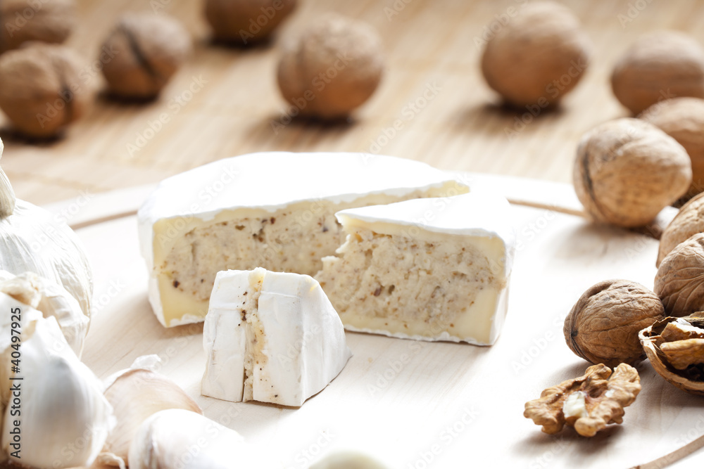 cheese brie filled with cheese mixture of chopped walnuts and ga