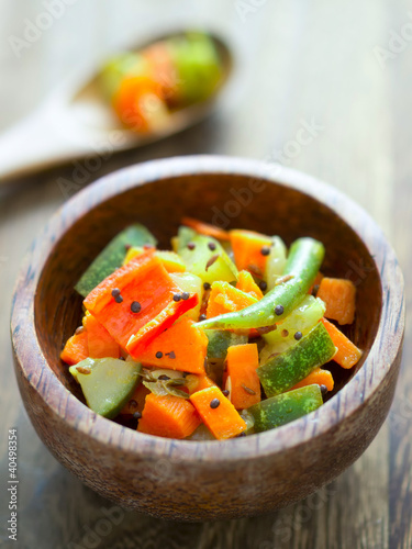 close up of a bowl of indian vegetable medley photo