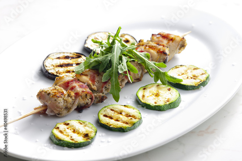 turkey skewer with bacon and grilled vegetables