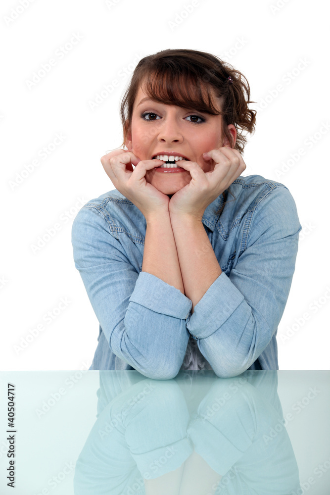 Nevous brunette chewing fingernails