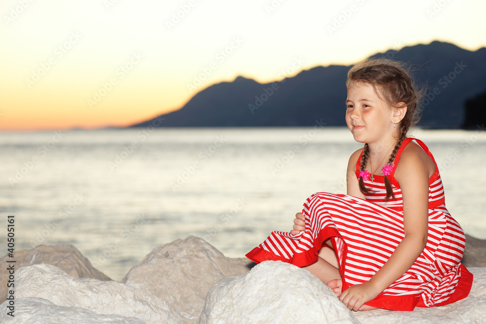 Young girl by the sunset