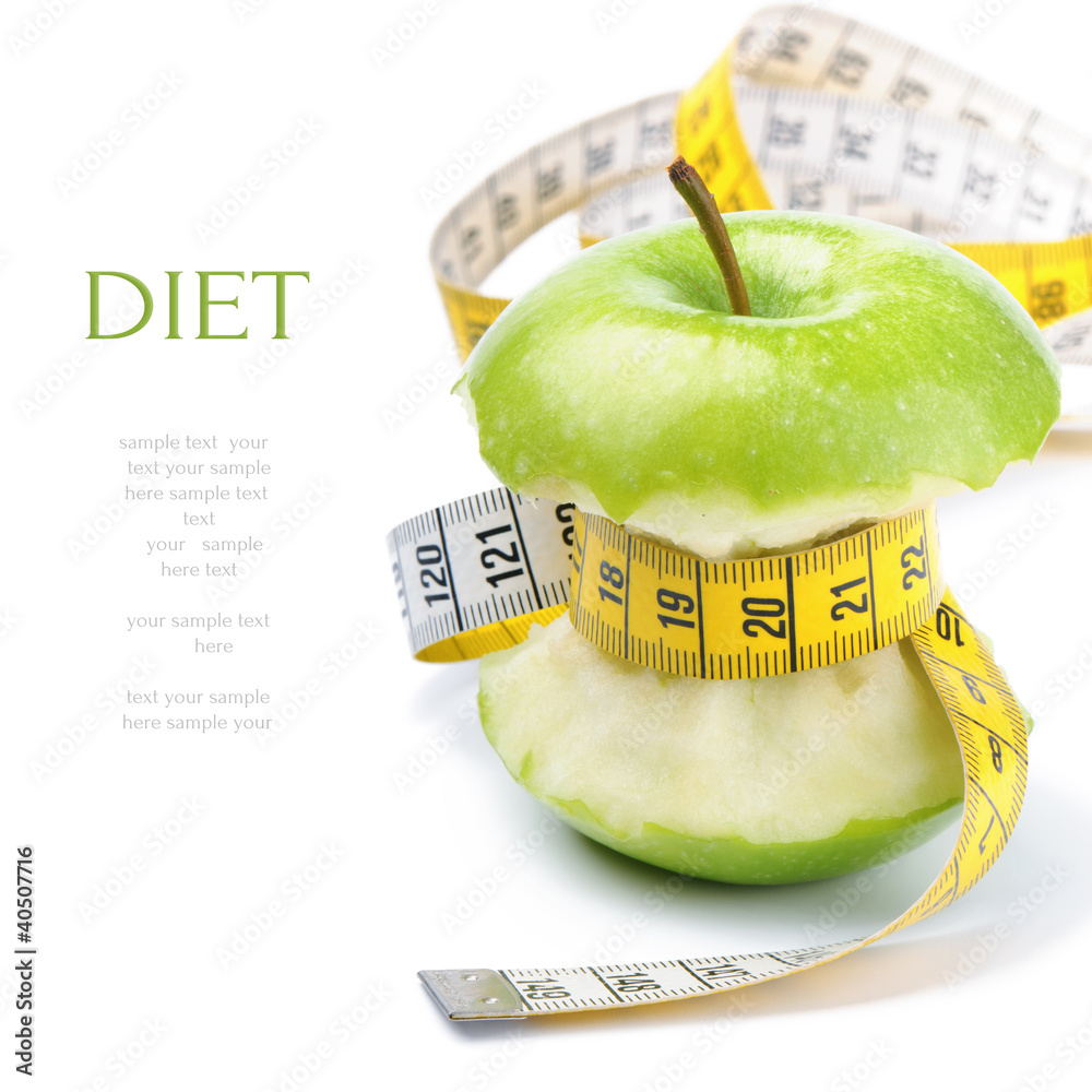 Green apple core and measuring tape. Diet concept - obrazy, fototapety, plakaty 