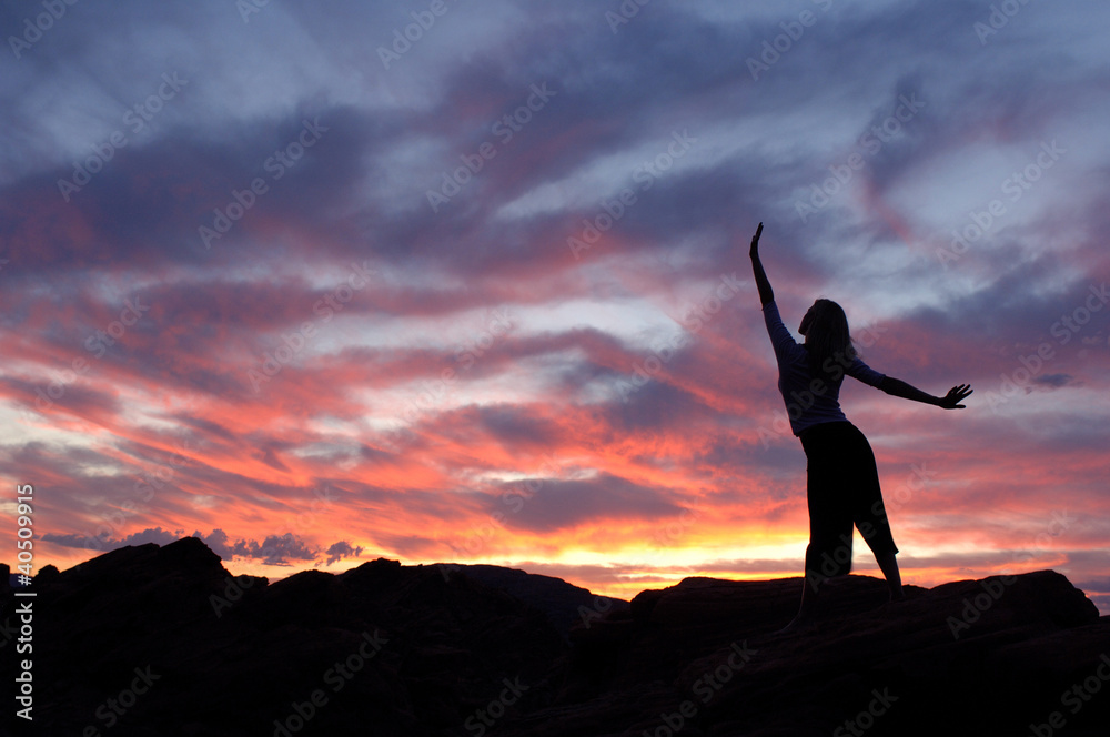 Inspiring sunset fills woman with joy.