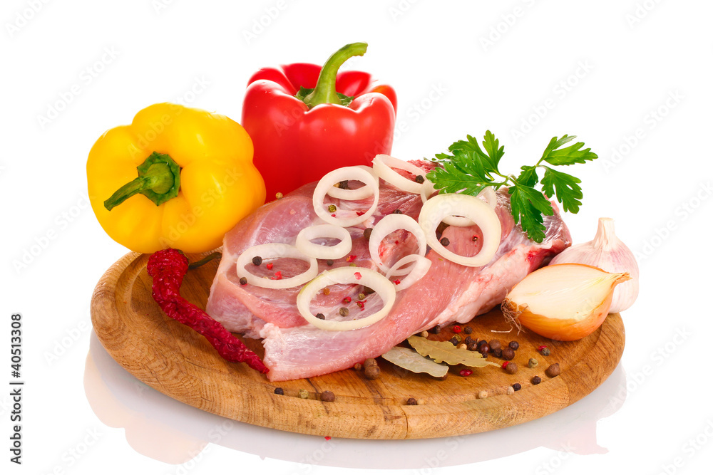 Raw meat and vegetables on a wooden board isolated on whitе Raw meat and vegetables on a wooden board isolated on whitе