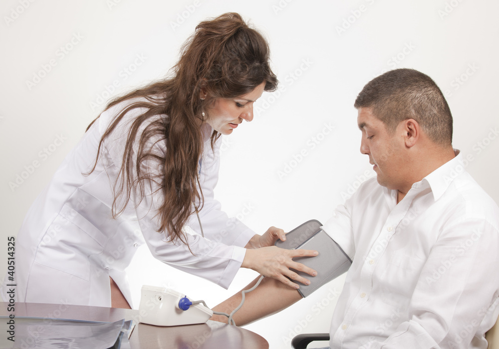 Fototapeta premium Doctor measuring blood pressure - studio shot