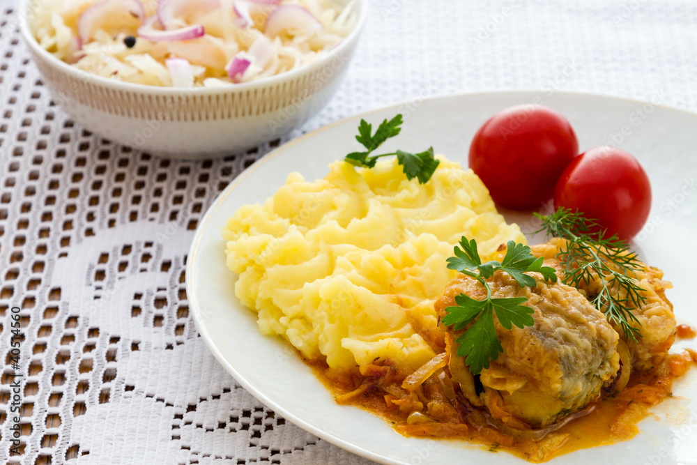 Grilled fish with mashed potatoes and salad on white plate. Grilled fish with mashed potatoes and salad on white plate.