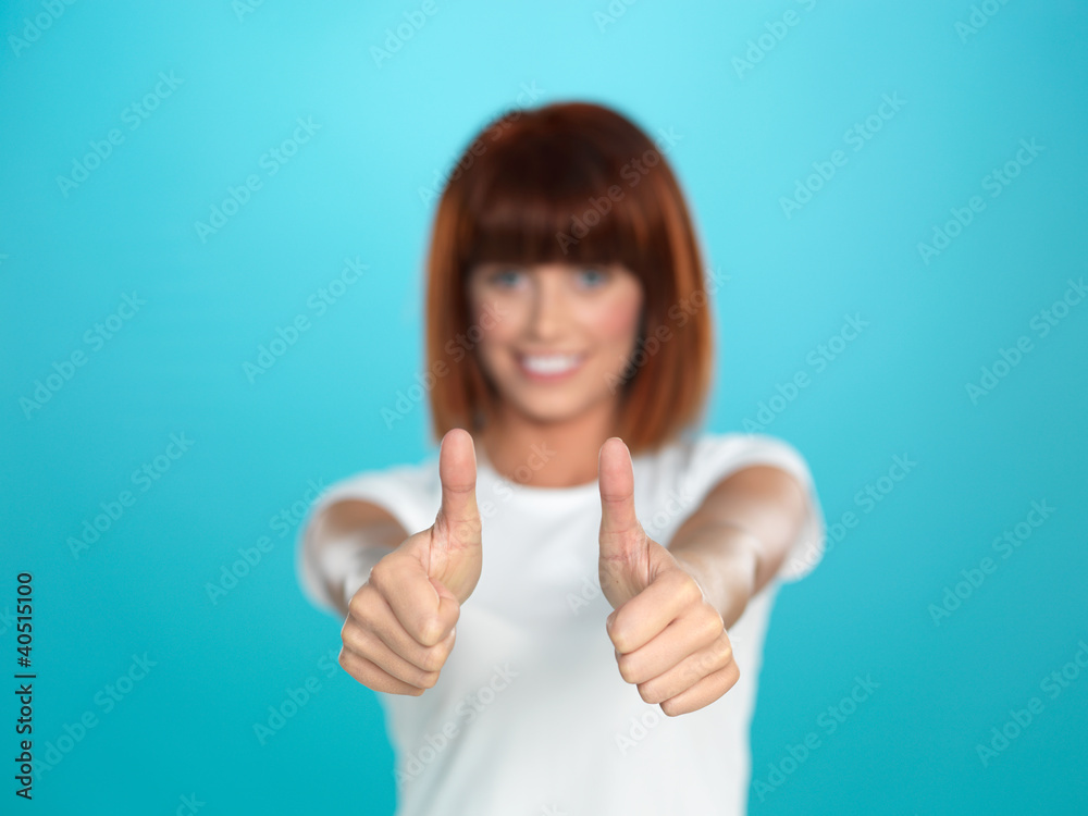 attractive woman smiling with her thumbs up attractive woman smiling with her thumbs up